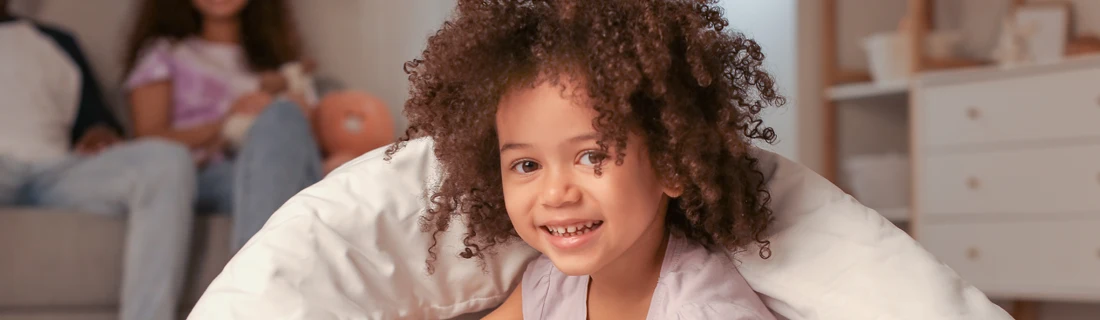 A young girl smiling.